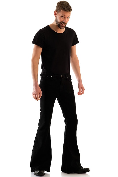 Man wearing black flare jeans with a dramatic leg opening