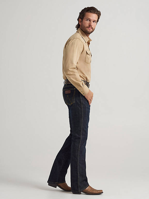 Man wearing dark bootcut jeans with leather boots