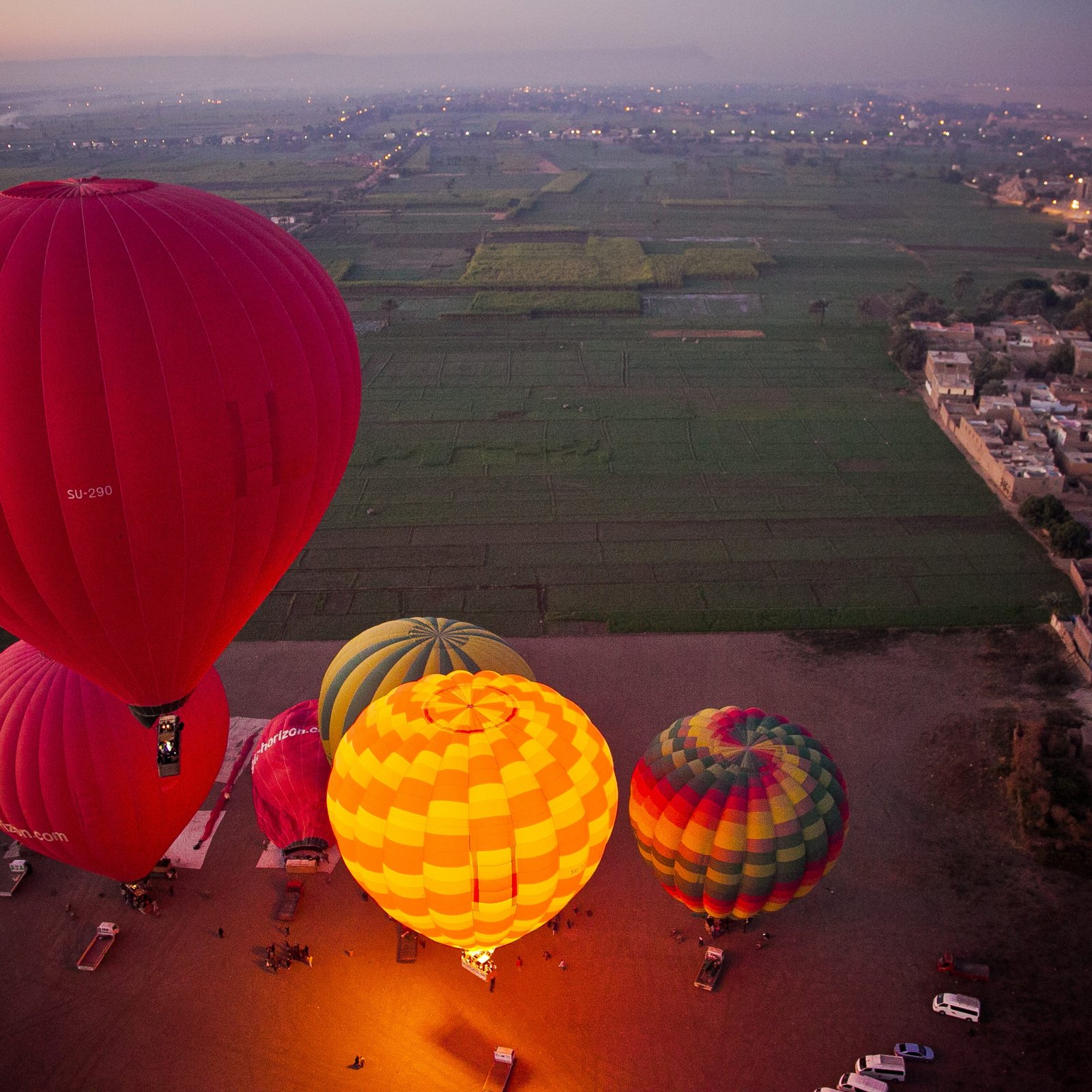 Glowing hot air balloons at dawn over Luxor