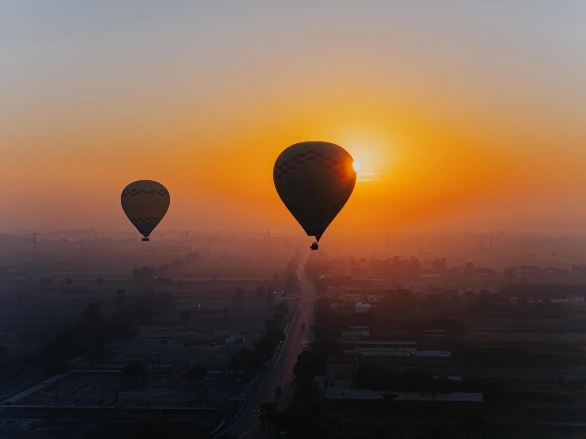 Hot air balloons at sunrise over Luxor