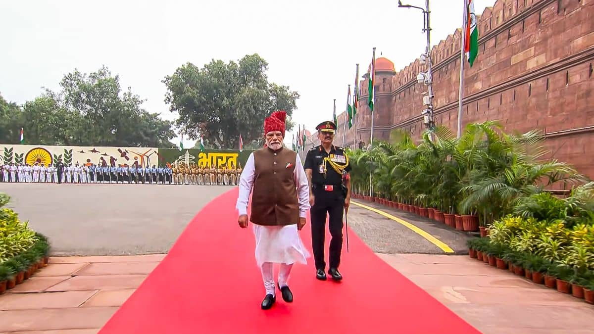 Narendra Modi walking on the red carpet at the Red Fort to inspect the Guard of Honour on Independence Day 2026