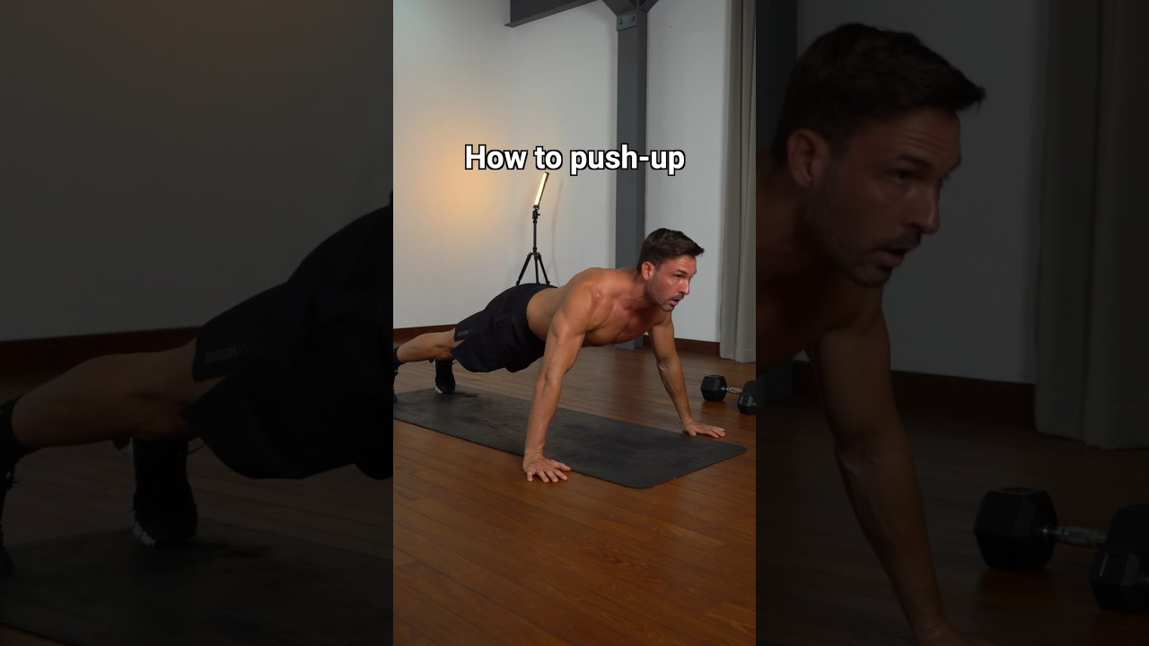 Man demonstrating proper push-up form on a yoga mat indoors