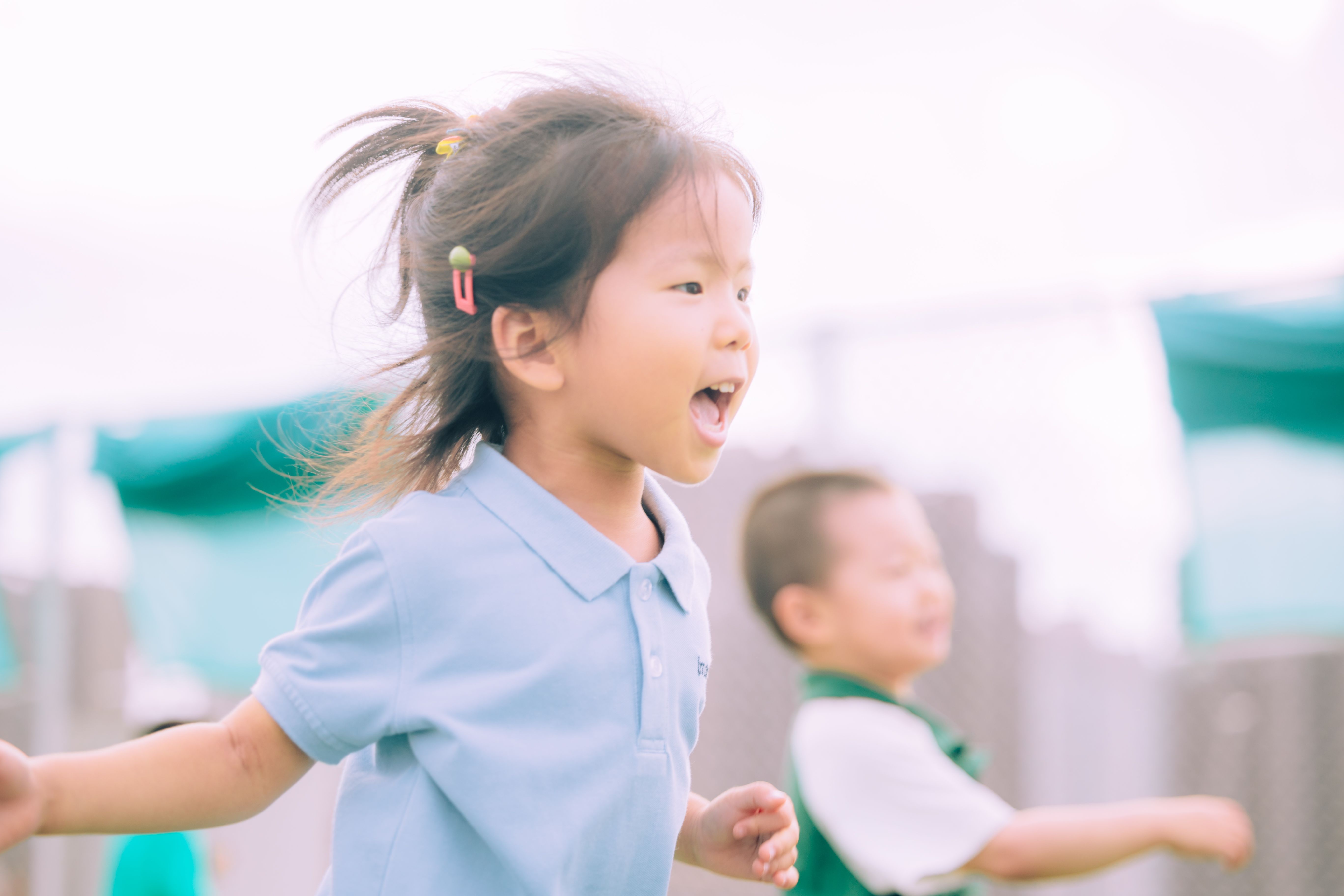Children playing actively outdoors in a park getting physical exercise