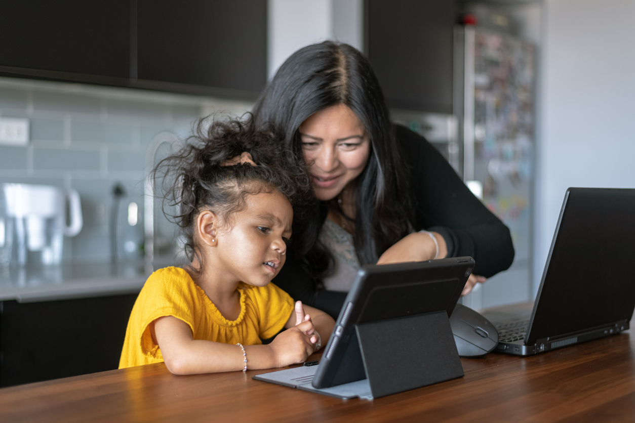 Parent guiding child while using tablet for positive supervised screen time