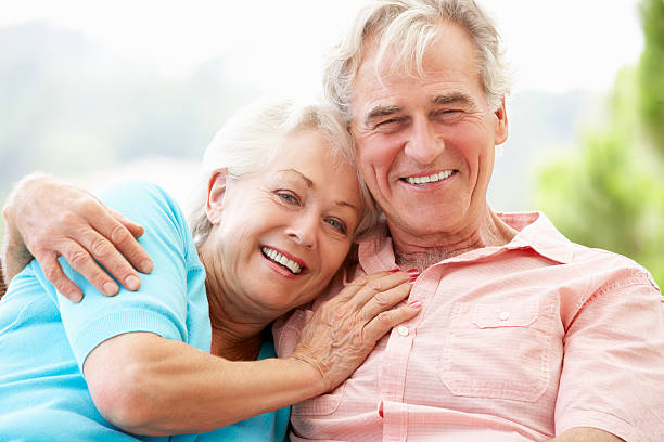 Smiling couple embracing in the garden