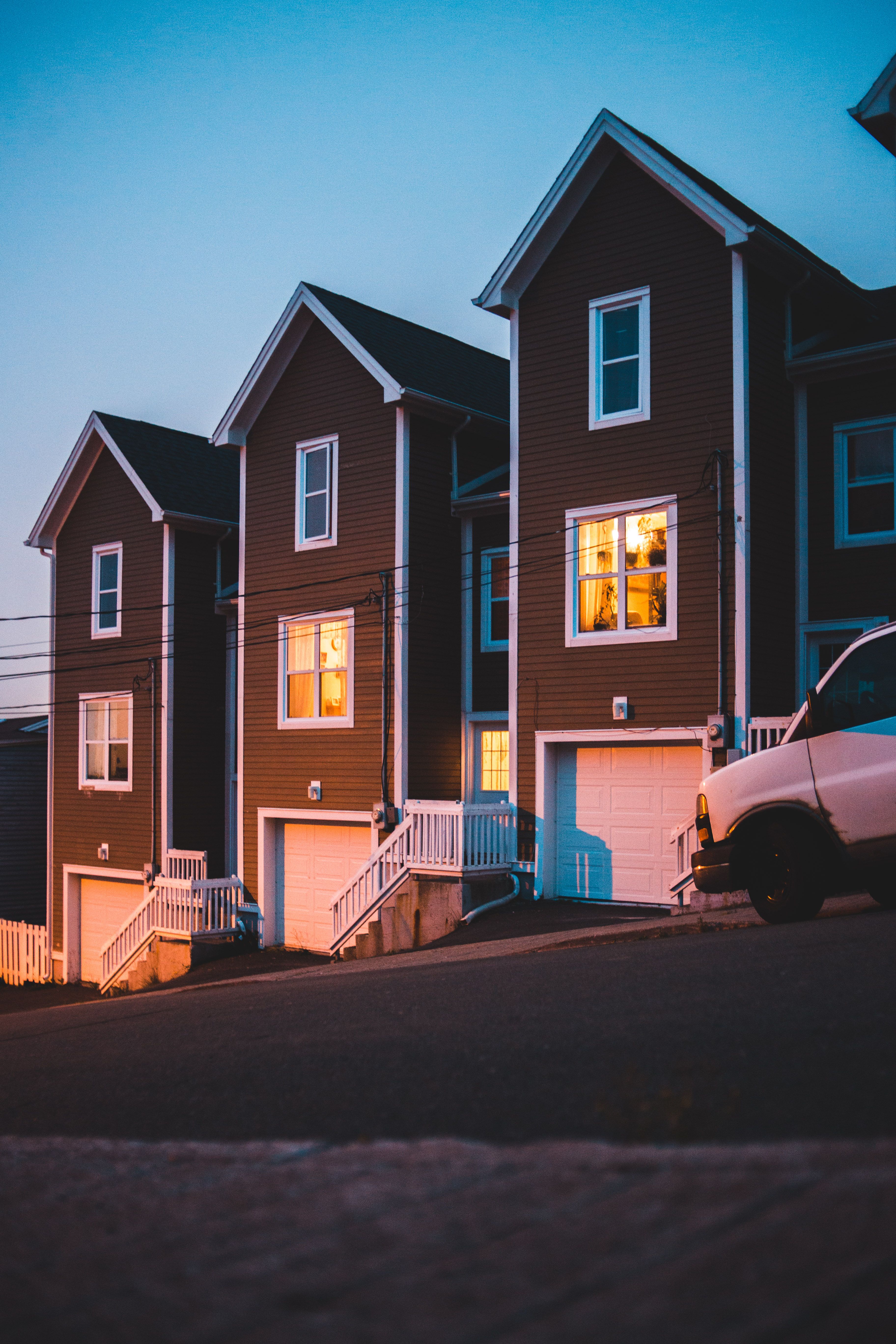 The Westside Collection — row of urban townhomes at dusk with warmly lit windows