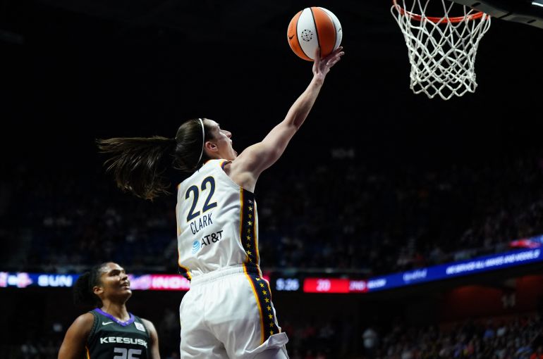 Caitlin Clark of the Indiana Fever finishing at the rim during a WNBA game