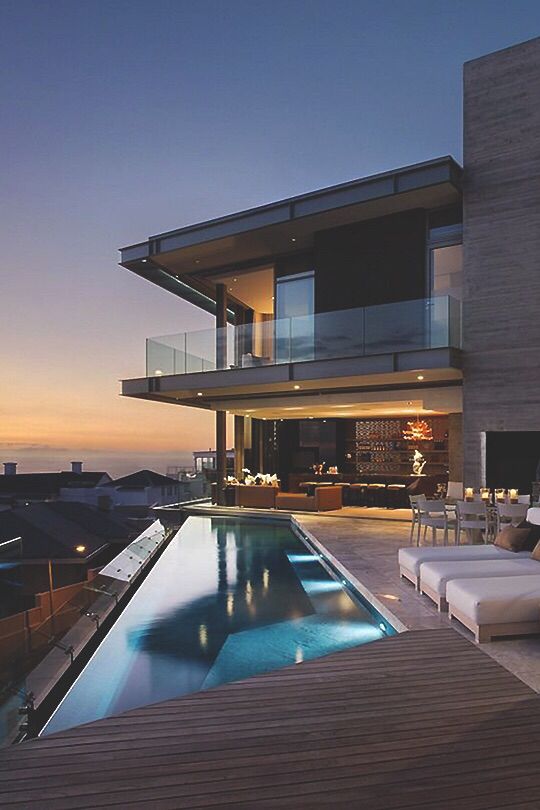 Modern architectural residence photographed at dusk with an infinity pool