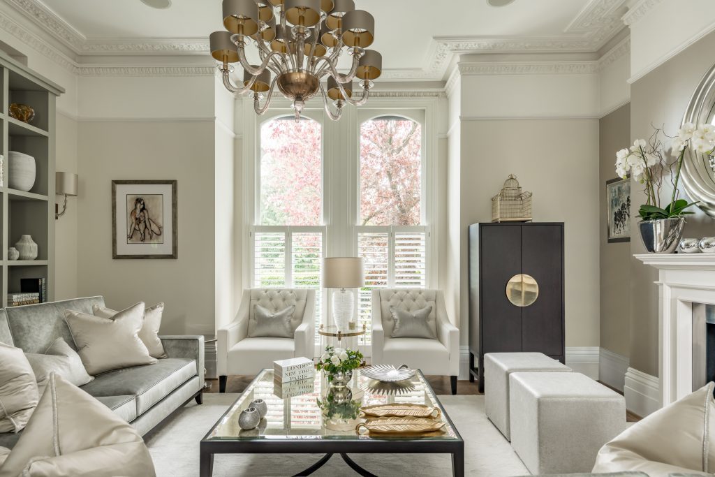 Elegant living room with soft neutral furnishings and sculptural lighting