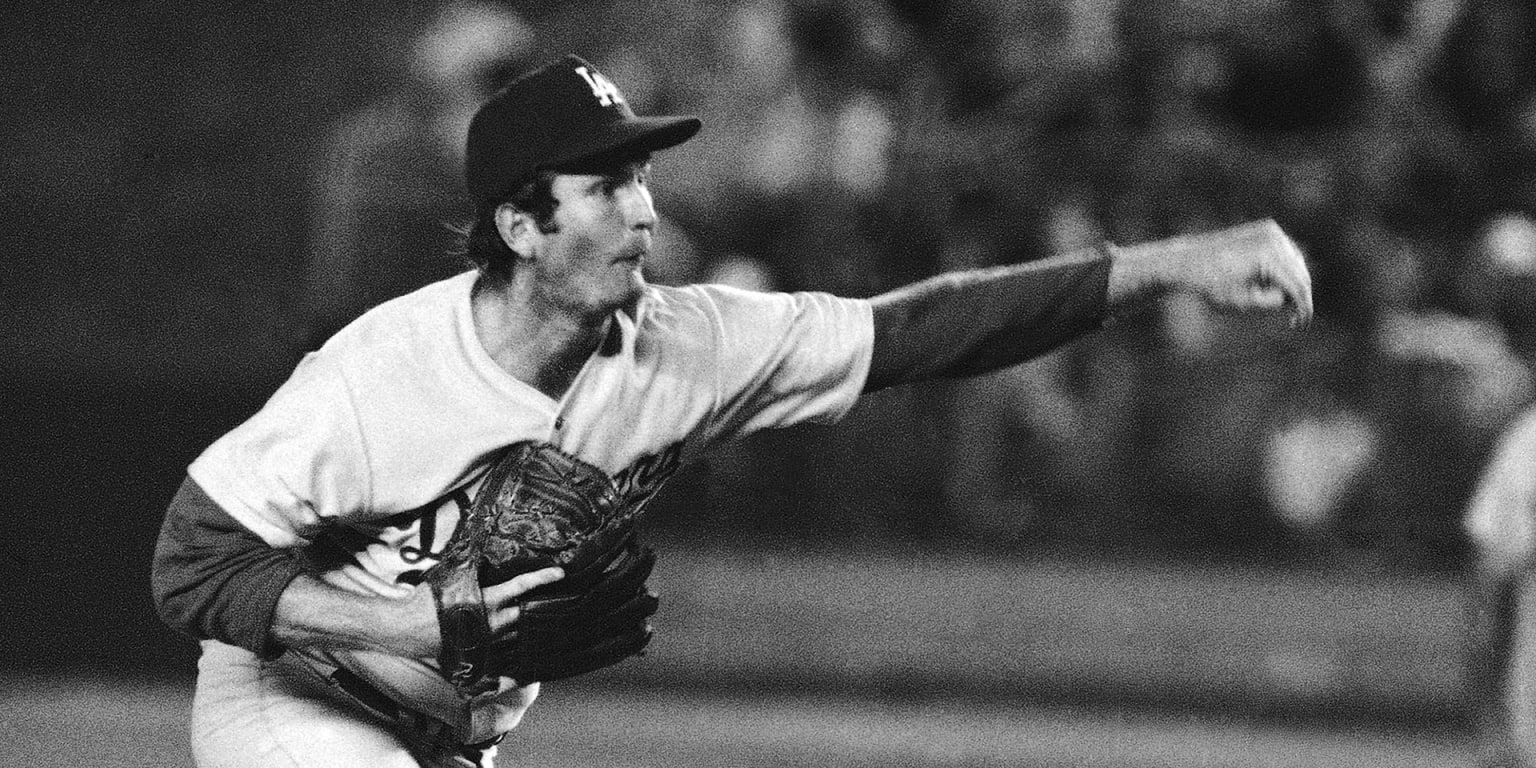Tommy John following through on a pitch for the Los Angeles Dodgers in the 1970s, before his pioneering elbow surgery
