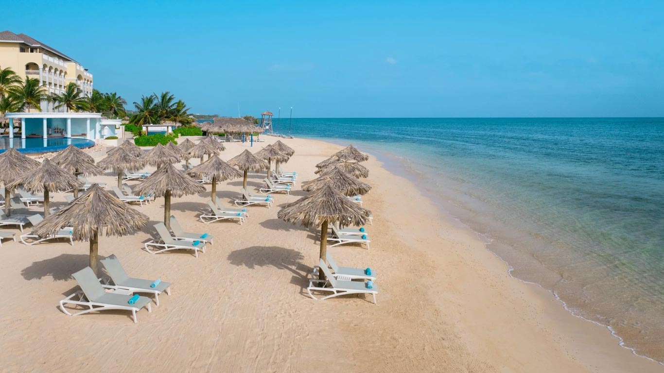 Iberostar Selection Rose Hall Suites — private beach with palapas and loungers