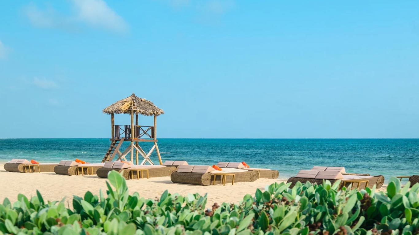 JOIA Rose Hall by Iberostar — beachfront with loungers and lifeguard tower
