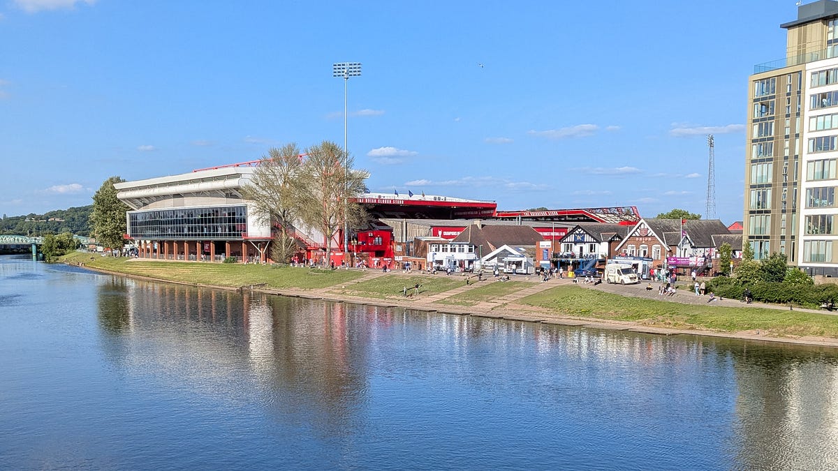 Nottingham Forest's City Ground stadium seen from across the River Trent on a clear summer day