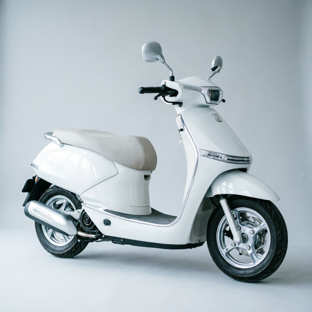 White Honda Vision automatic scooter, side view