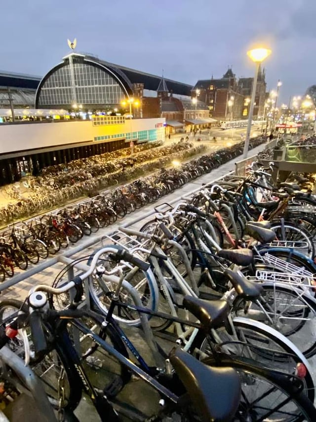 Thousands of bicycles parked outside Amsterdam Central Station at dusk, one of the busiest hotspots for e-bike theft in the Netherlands