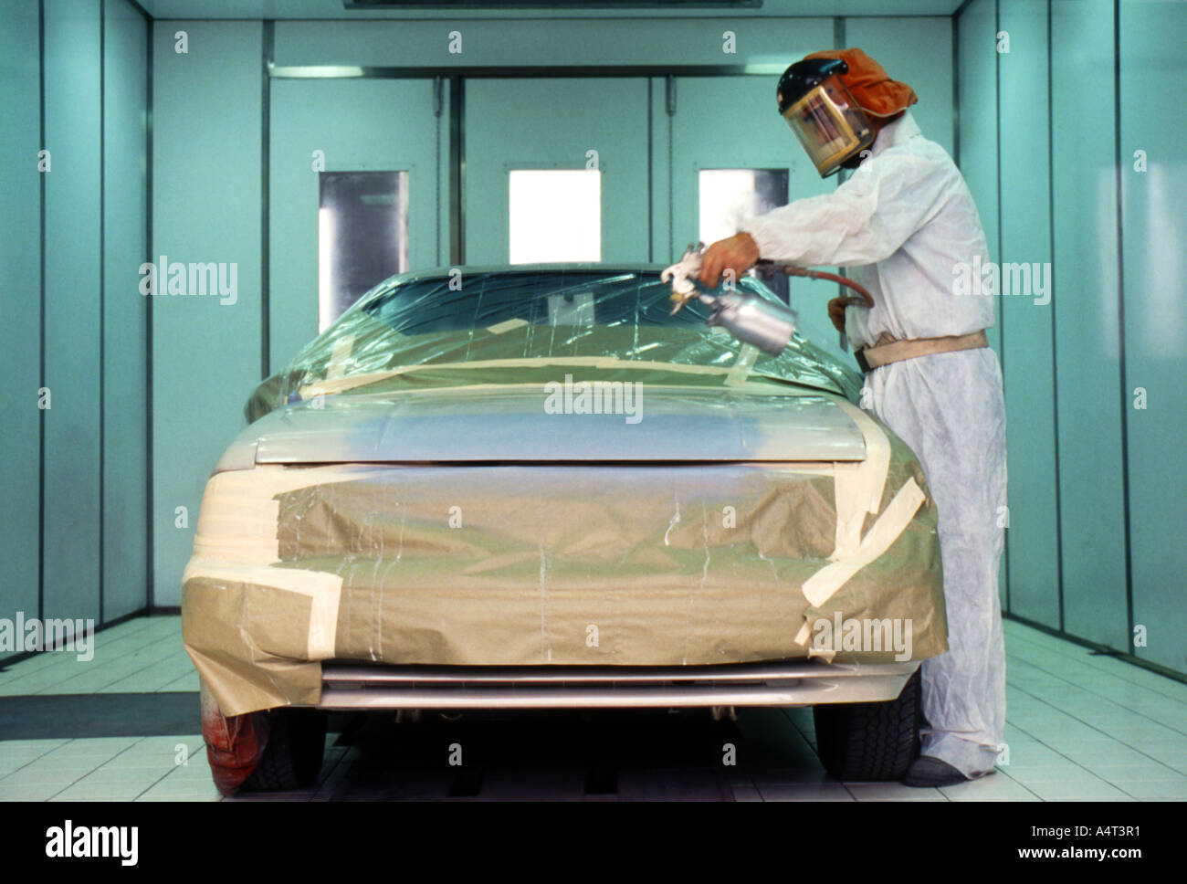 Professional car spray painting inside paint booth