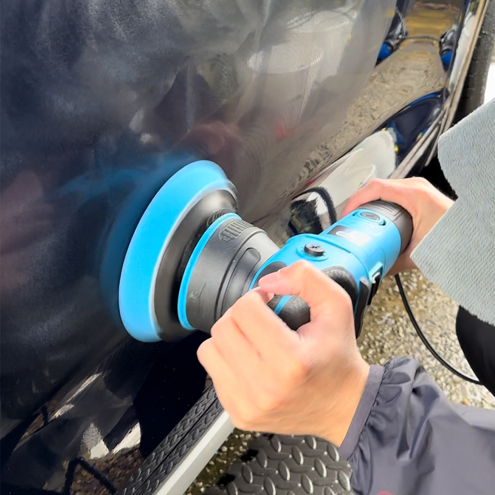 Machine polishing and paint correction on black car paint