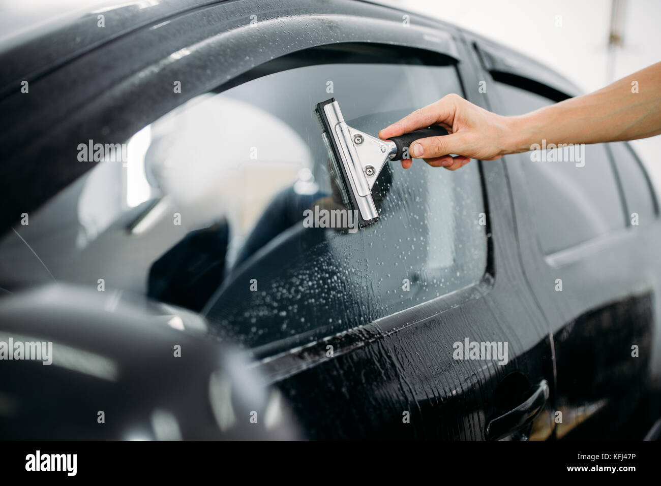 Car window tint film installation with squeegee