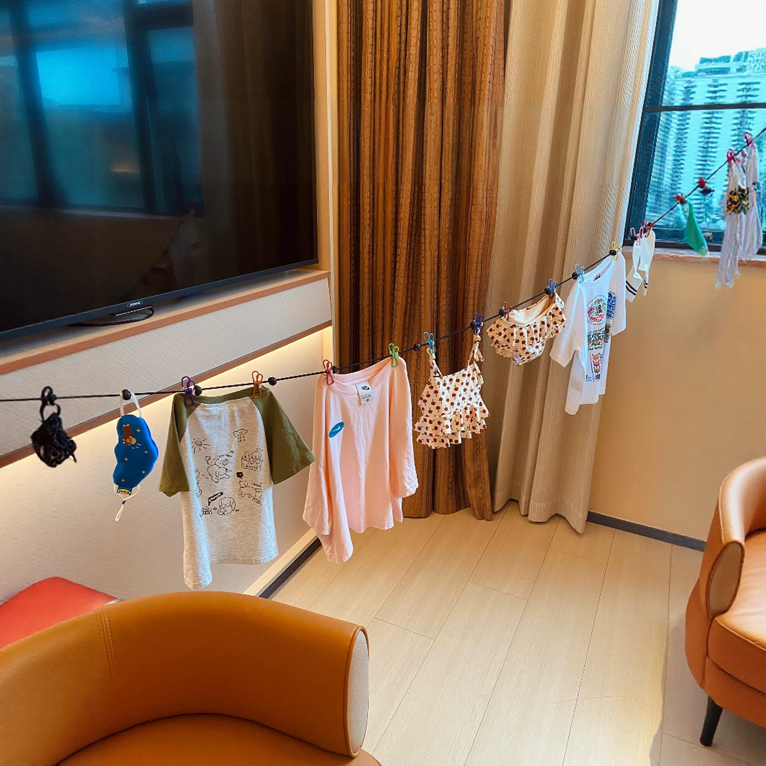 Washed clothes drying on a line across a hotel room