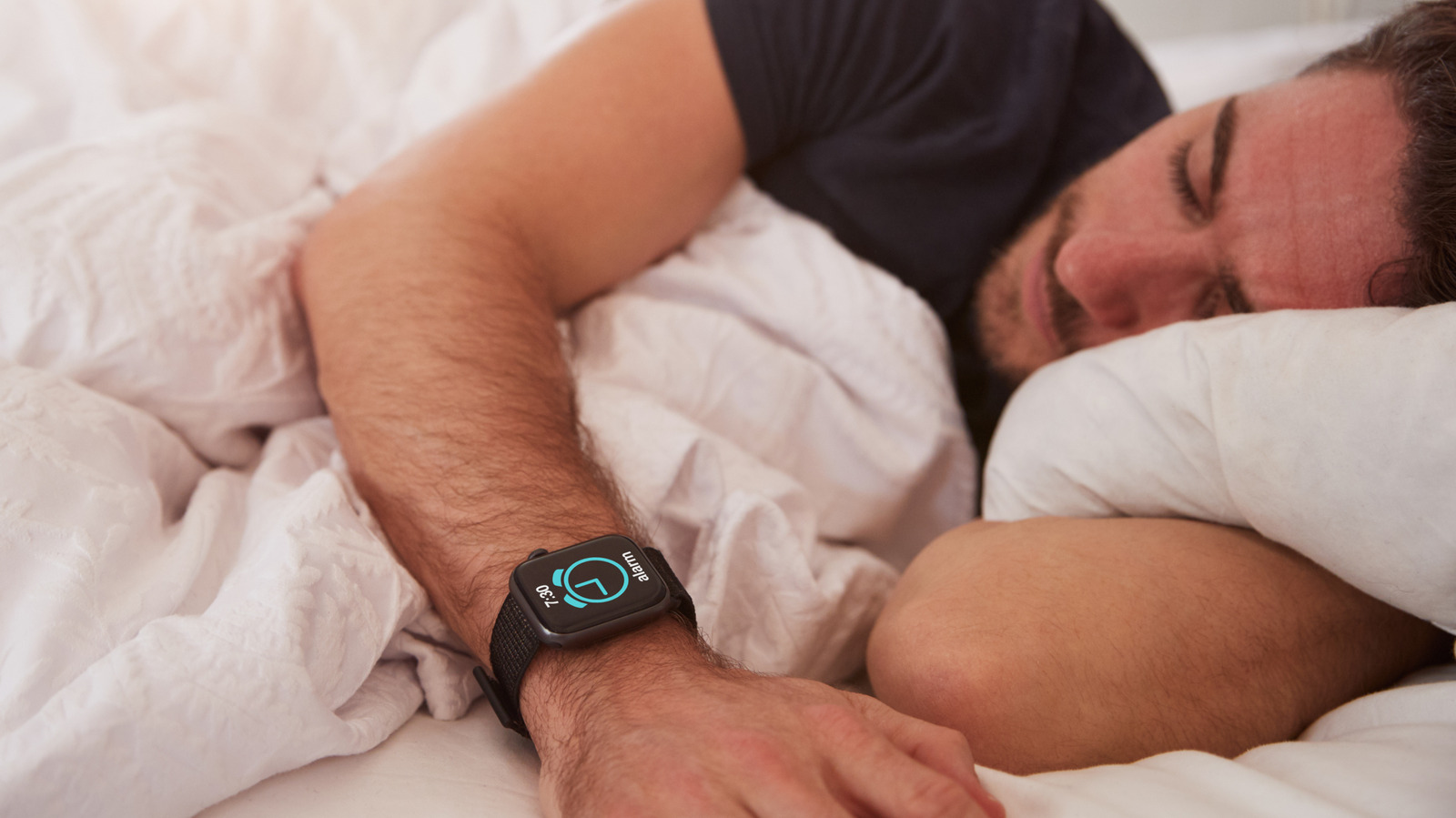 A man asleep wearing a smartwatch sleep tracker