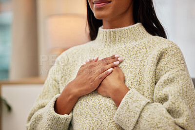 A woman placing her hands on her chest while breathing calmly