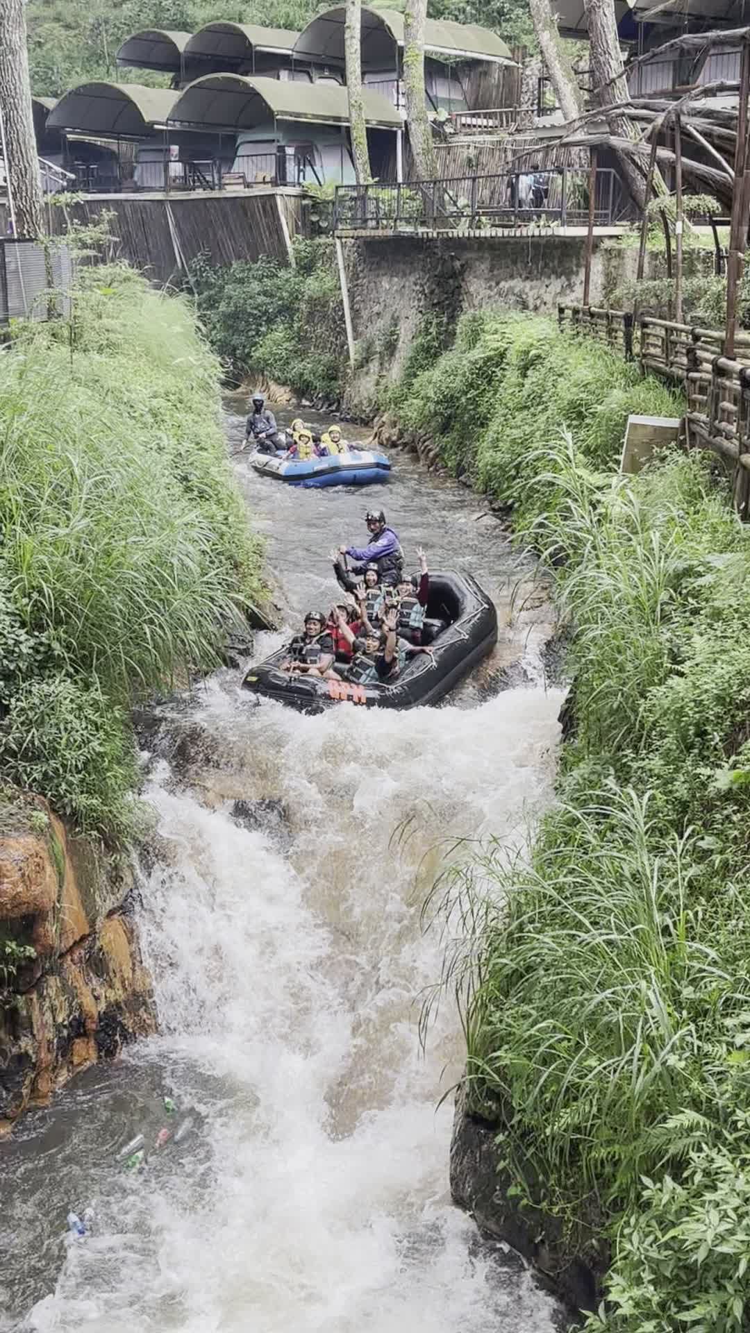 Rafters dropping through rapids on the Telaga Waja white water rafting course in Bali