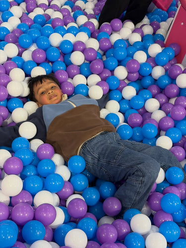Child relaxing in the ball pool
