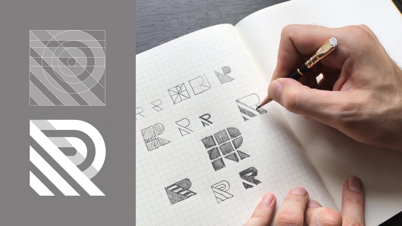 Hand sketching logo letter variations in a grid notebook