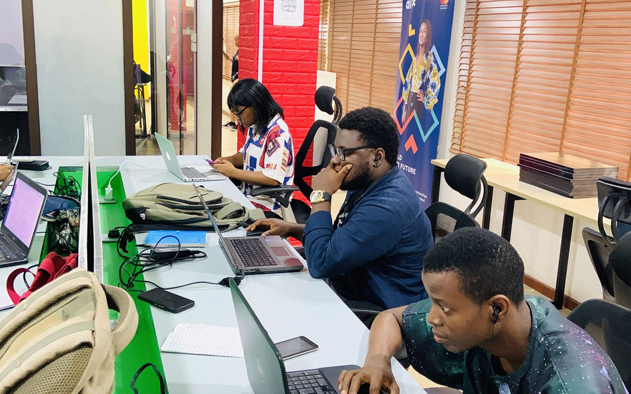 Young Nigerian developers training on laptops at a tech lab in Lagos