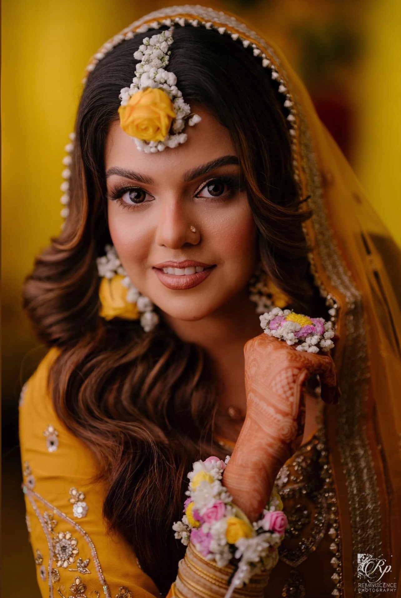 Mehndi bride in yellow with floral jewellery