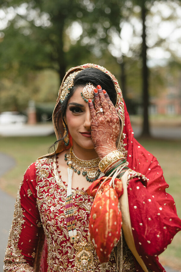 Bride behind henna-painted hand